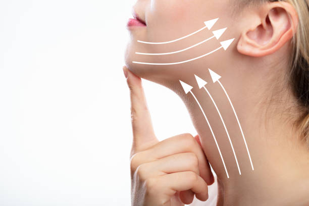 Woman With Arrows On Her Face Woman With Arrows On Her Face Over White Background  A person doing the exercise to reduce double chin. stock pictures, royalty-free photos & images